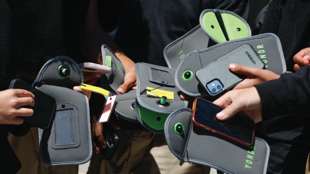 Students unpack their phones from their protective bags during the school day at Bayside Academy in San Mateo, California. The school district has banned cell phones at four of its middle schools by 2022. (Lea Suzuki/San Francisco Chronicle via Getty Images)